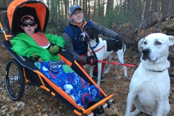 x-rover-all-terrain-special-needs-buggy-in-woods-with-older-child